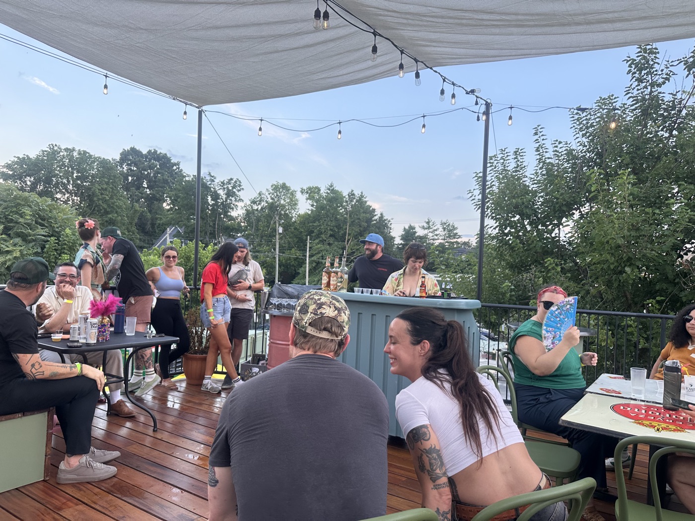 Guests seated and mingling on the rooftop in the evening