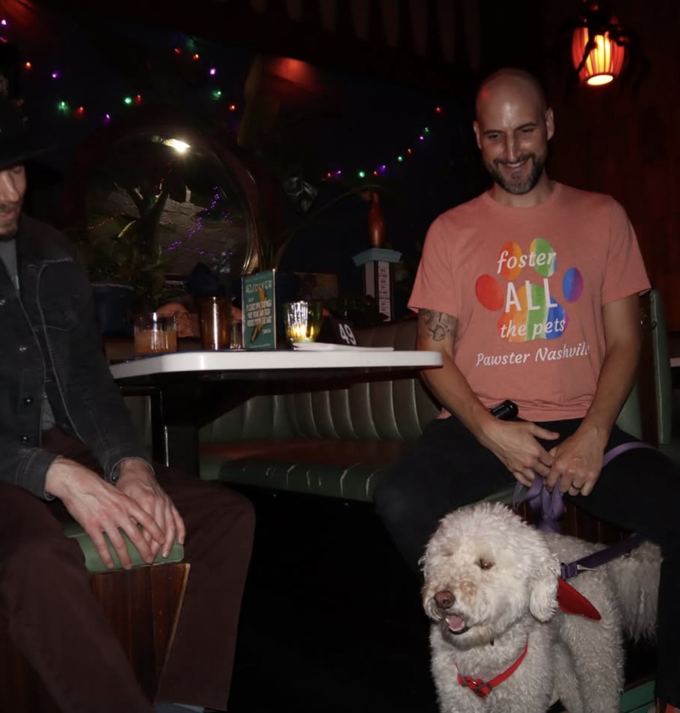 Guest in a Pawster Nashville shirt with his dog